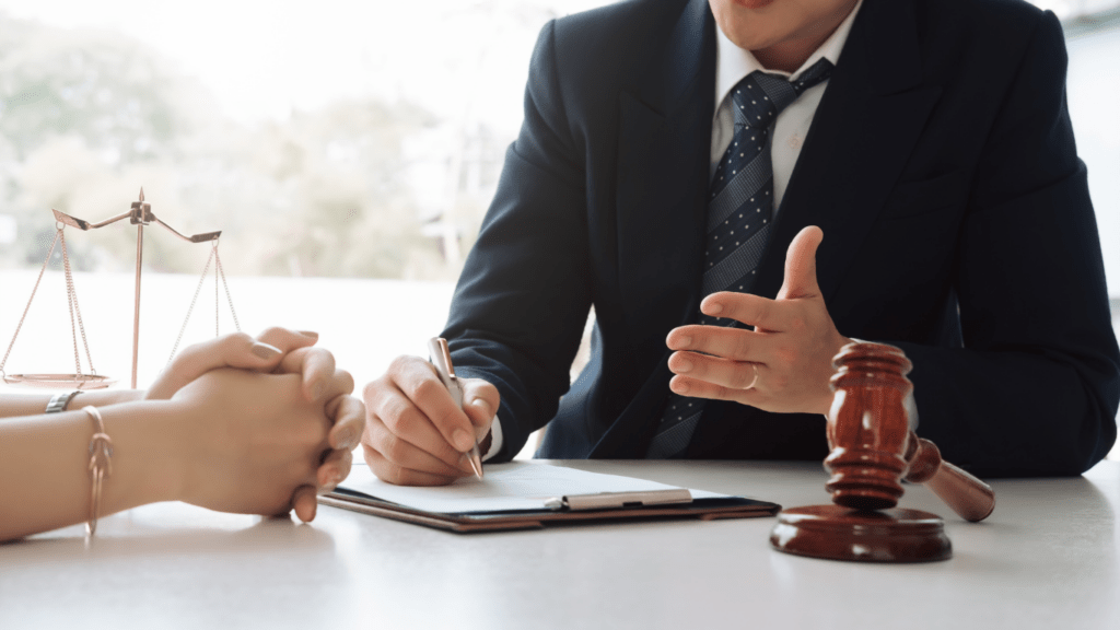 a person in a suit is talking to a person at a desk