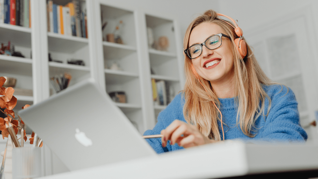 Smiling person working on laptop 