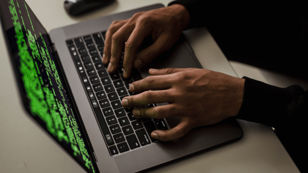 a person typing on a laptop computer