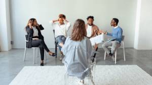 a group of people sitting on chairs in an office