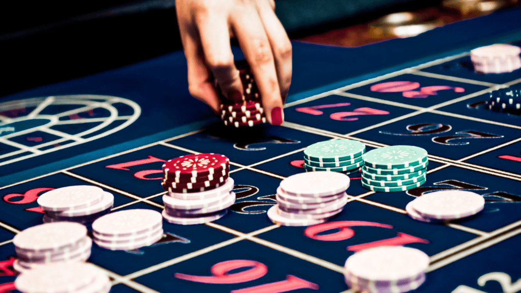 A woman placing bets and playing roulette at a Casino.