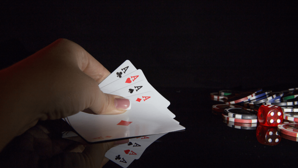 a person holding a pair of playing cards