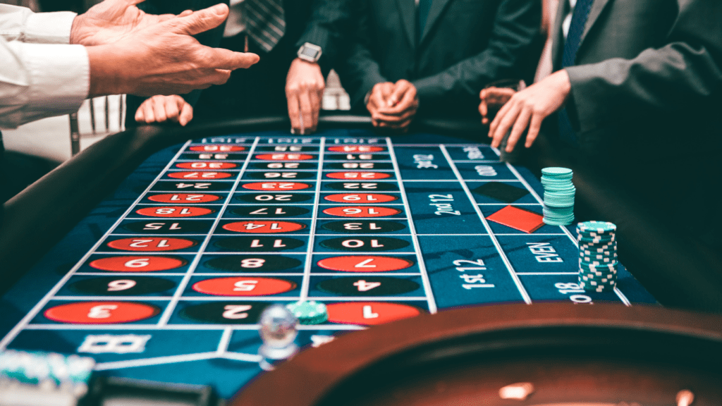 a person in a suit and tie playing cards at a casino table