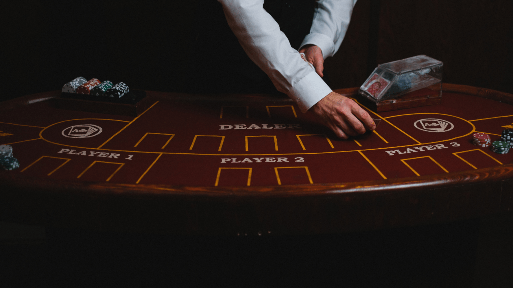 a person in a suit is playing cards on a casino