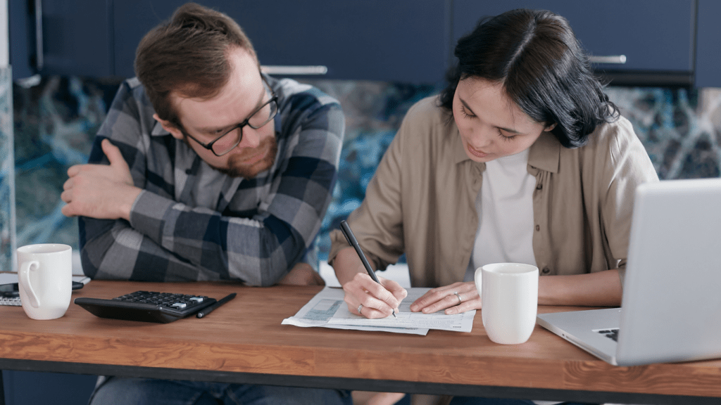 two person in front of laptop